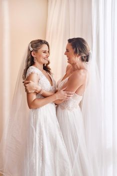 This is finally happening. two attractive young brides holding each other in excitement before their wedding.