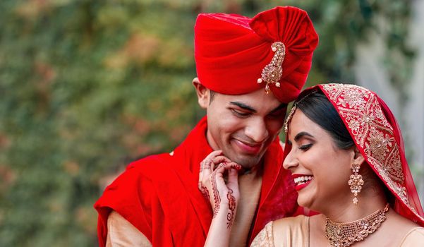 They couldnt be happier. a young hindu couple on their wedding day.