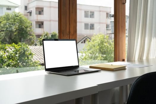 Blank screen computer laptop on working desk.