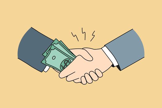 Businessmen shake hands give bribe