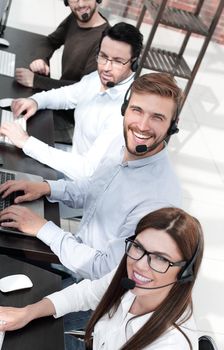 close up.smiling call center specialists in the workplace
