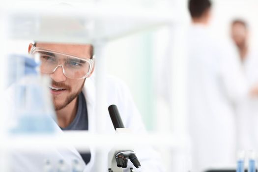 closeup.male chemist on blurred background laboratory
