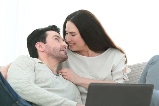 man with his girlfriend chatting on laptop at home indoor