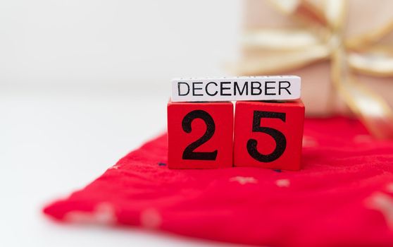 December 25 is lined with red cubes along with December lettering on a red Christmas background. Christmas Eve.