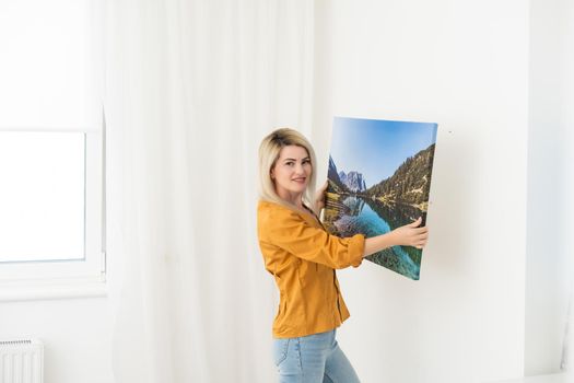 Young woman in yellow blouse hold canvas. Minimal art concept.