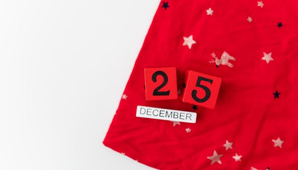 December 25 is lined with red cubes along with December lettering on a red Christmas background. Christmas Eve.