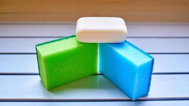 Set for washing and cleaning.Green blue sponge and white soap