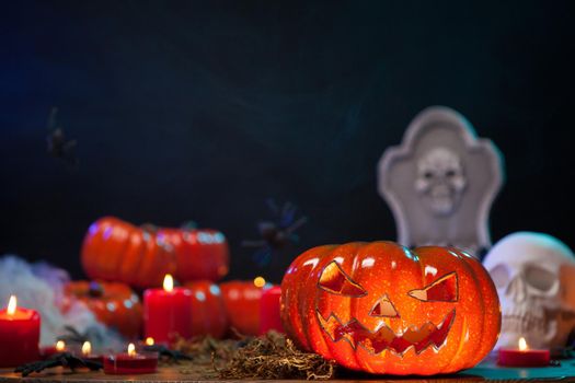 Halloween candles lighting a creepy carved orange pumpkin
