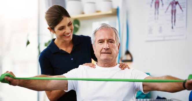 Hes doing a great job. an attractive young female physiotherapist working with a senior male patient.