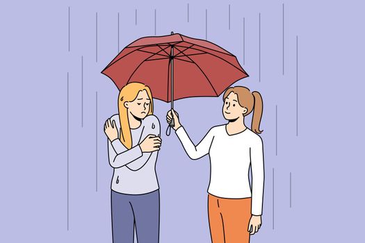 Caring woman share umbrella with friend