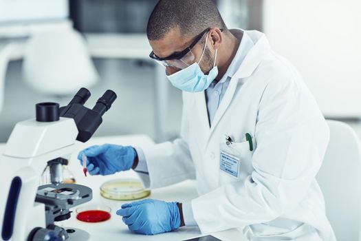 Medical, healthcare and science professional testing monkeypox, ebola or marburg virus under microscope in medical research. Biologist, scientist or pathologist examining DNA chemical reaction in lab