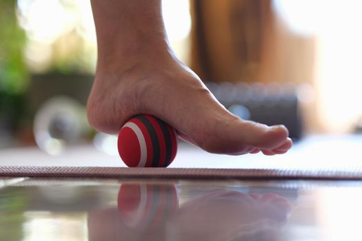 Massage ball applies pressure to painful area on foot