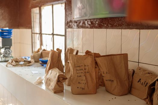 Packages filled with freshly baked roasted coffee to preserve its aroma on table