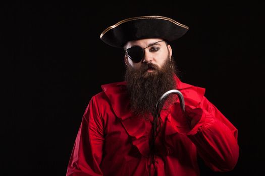 Portrait of handsome bearded man wearing medieval pirate clothes for halloween carnival