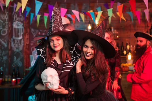 Portrait of excited young witches for halloween party