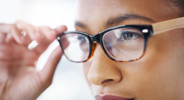She sees success is on the way. Closeup shot of an attractive young businesswoman wearing spectacles in a modern office.