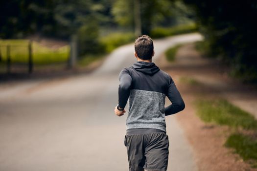 Turn your back on your excuses. a sporty middle-aged man out running.