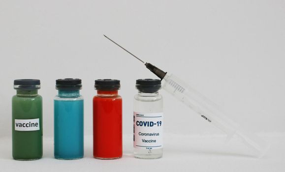 White, red, green and blue ampoule with vaccine.