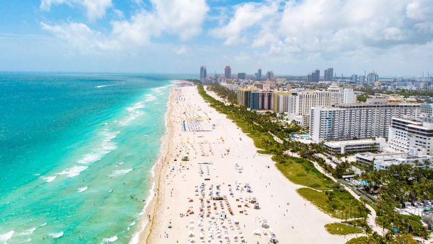 Drone aerial view at Miami South Beach Florida, Beach with colorful chairs and umbrellas