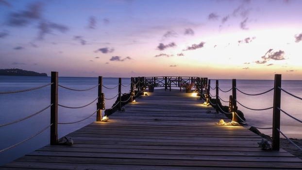 wooden pier in the ocean during sunset at Saint Lucia or St Lucia Caribbean