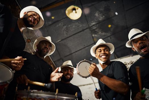Its carnival time. Portrait of a group of musical performers playing drums together.