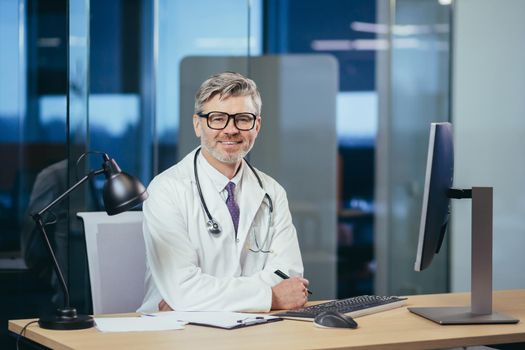 Portrait of an experienced doctor with glasses, a senior and experienced man looking