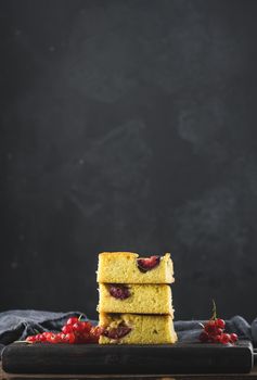 Stack of square slices of baked plum biscuit cake	