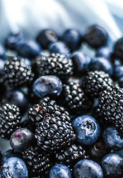 bluberries and blackberries - fresh fruits and healthy eating styled concept