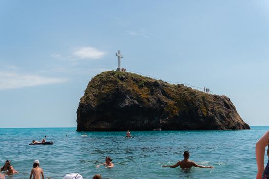 People bathe Fiolent cross Crimea Cape sea summer rock monastery, from near ukraine from black for blue sky, cliff europe. Scenery outdoor,