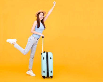 Happy young woman with luggage isolated on yellow background ,summer,travel concept.