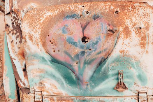 Rusted heart with hit with bullet holes abstract