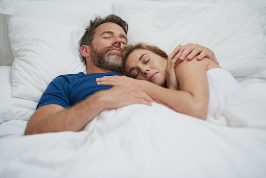 Be each others sweetest dreams. a happy middle aged couple relaxing in bed together.