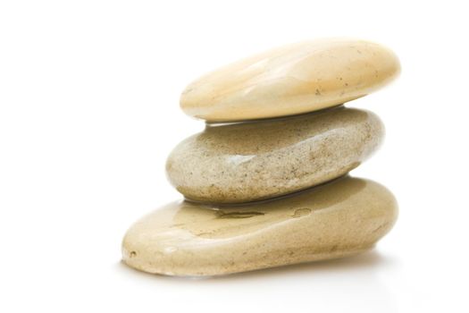 pile of hot massage stones - beauty, spa and body care styled concept