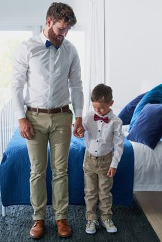 Like father like son. an adorable little boy and his father dressed in matching outfits.