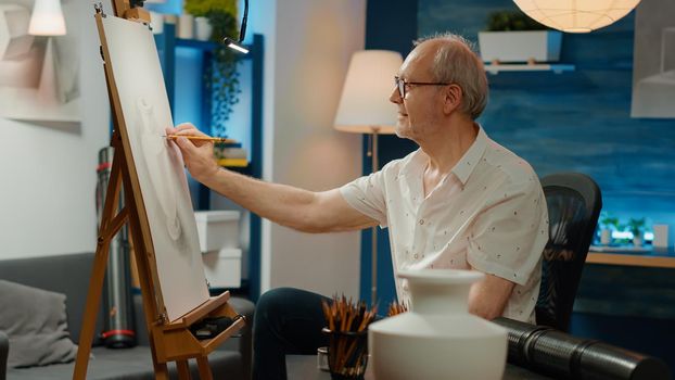 Old person using artistic skills to draw masterpiece of vase