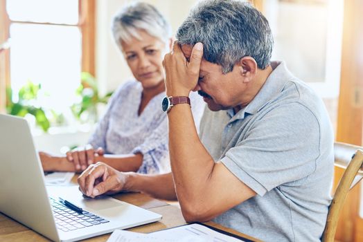 When debt becomes a reality. a mature couple looking stressed out while managing their paperwork together at home.
