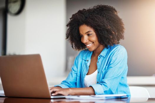 Wake up and work for it, its that easy. an attractive young woman working on her laptop at home.