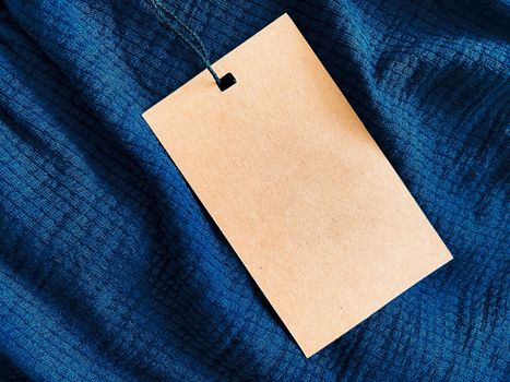 Blank fashion label tag, sale price card on luxury fabric background, shopping and retail