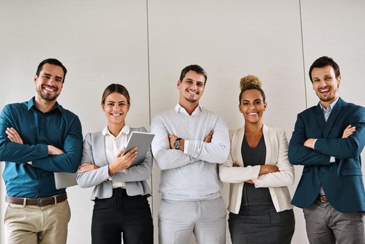 Its confidence that shines through them all. Portrait of a group of businesspeople standing in an office.