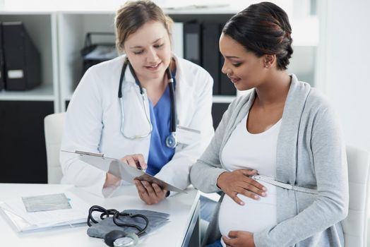 This is how easy the process is. a confident female doctor consulting with a pregnant patient at a hospital during the day.