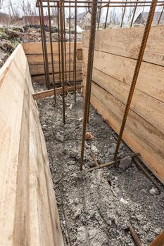 Reinforcement of the strip foundation, the trench is partially covered with earth