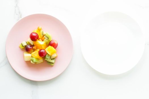 juicy fruit salad for breakfast on marble, flatlay - dieting and healthy lifestyle concept