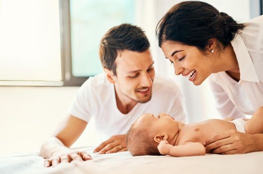 Babies fill the world with love. a happy mother and father bonding with their baby boy at home.