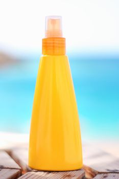 suntan lotion on the beach - summertime, skincare and beauty styled concept