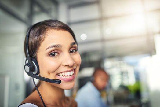 Cant wait to answer your call and answer any queries. a young attractive female customer support agent working in the office.