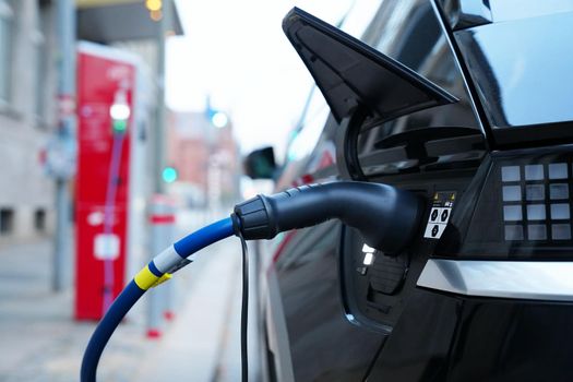 Electromobile charging plug is inserted into vehicle charging socket.