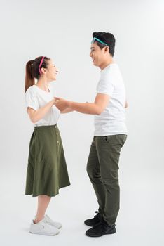 Full length shot of asian couple isolated on white. Man in casual attire chilling with girlfriend