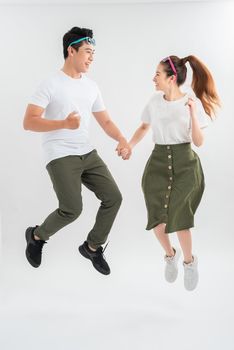Full length shot of jumping couple having fun together.