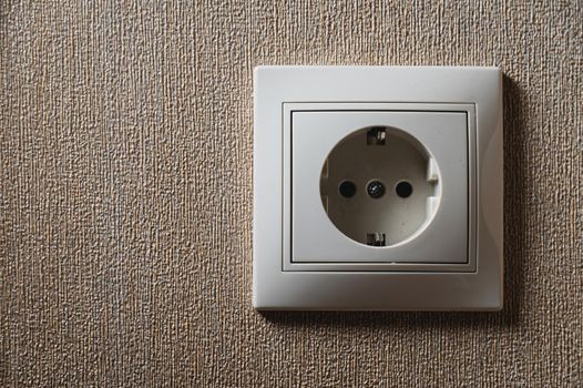 One white electrical socket at home. Close-up