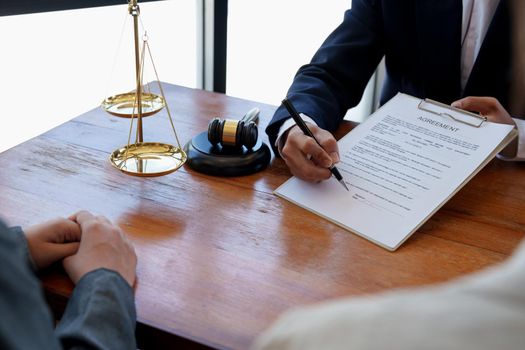 The hand of a business man is using the index finger to let the customer sign the contract, contract, business agreement.